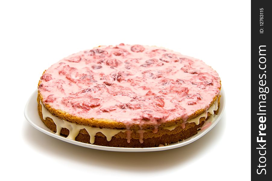 Homemade strawberry cake on a platter, isolated on white background