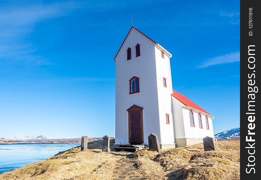 Church on lake Ulfljotsvatn, known as Ulfljotsvatnskirkja, is landmark of southern of Iceland, beautiful viewpoint under clear blue sky. Church on lake Ulfljotsvatn, known as Ulfljotsvatnskirkja, is landmark of southern of Iceland, beautiful viewpoint under clear blue sky