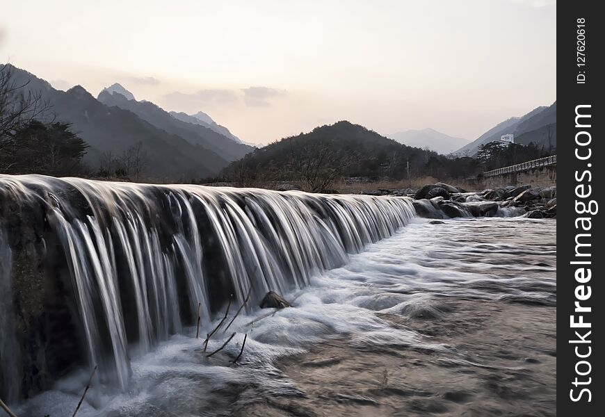 Mountain river. Water on river rapids. Photo on exposure. South Korea