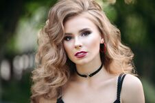 Portrait Of A Beautiful Blonde Girl. In A City Park Stock Photo