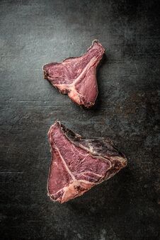 Close-up Raw T-bone Steak On Black Cutting Board Stock Photography