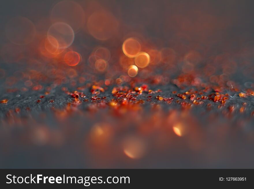 Abstract red bokeh on a black background. Defocused. Free space for text.