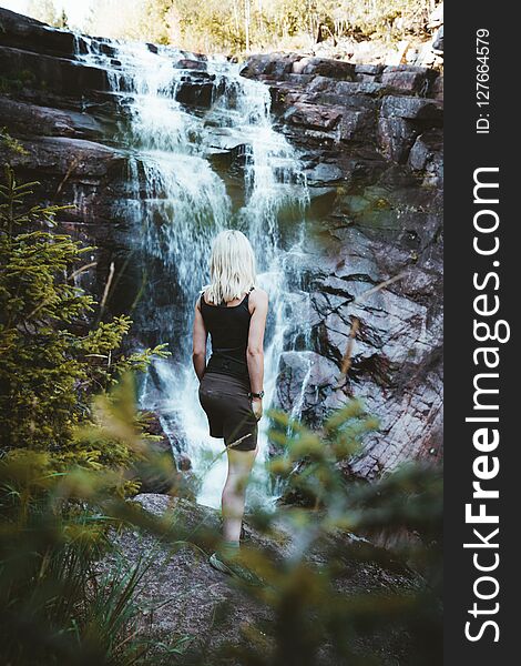 A girl hiking at the Solbergelva river in south Norway