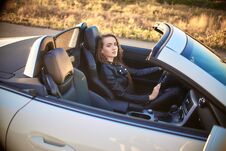 Beautiful Girl With Long Hair In A Leather Jacket And Leather Pants In Sunglasses Sits In An Expensive Car At Stock Image Beautiful Girl With Long Hair In A Leather Jacket And Leather Pants In Sunglasses Sits In An Expensive Car At Stock Image