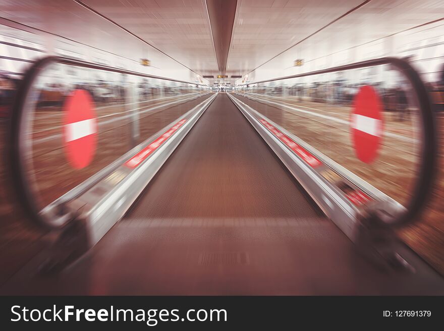 Moving waklway in the airport terminal, travel concept. straight flat escalator. motion effect. entry banned a badge of. there is no way.