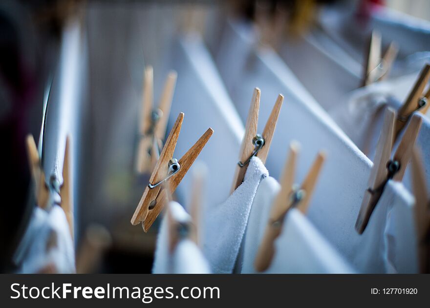 Clothes pegs on the clothesline with cotton white clothes