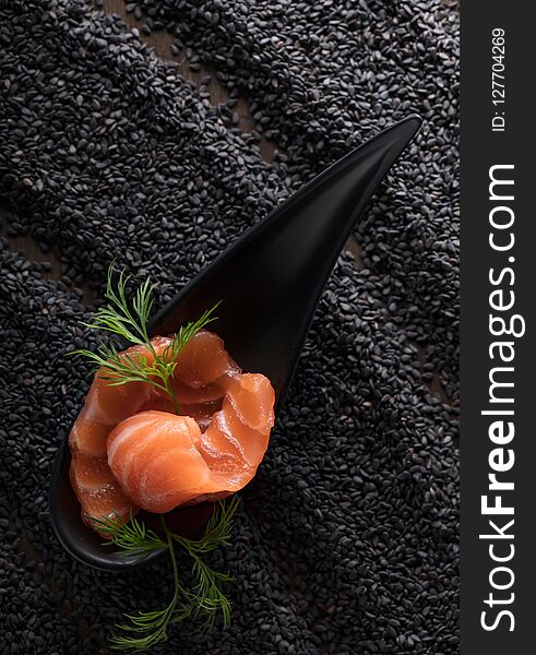 Salted Salmon With Dill On The Background Of Black Sesame.