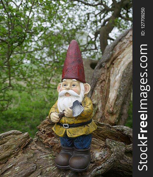 Garden Gnome with an ax in the fairytale forest. Garden Gnome with an ax in the fairytale forest