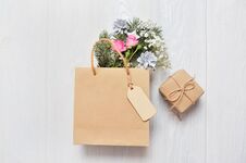 Christmas Mockup Shopping Concept. Kraft Package With Wooden Tag And Xmas Decor Fir Branches, Pink Roses, Cones With Place For You Stock Images