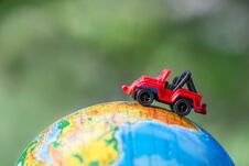 A Car On Globe On Green Background. Miniature Car Toy On Globe. Travel Concept Royalty Free Stock Images