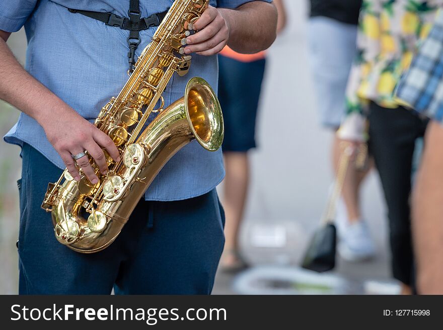 The street musician playing saxophone.