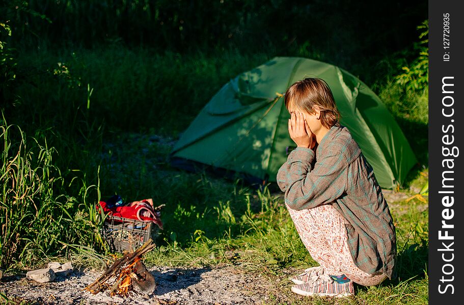 Morning in the woods, outdoor activities, woman makes a fire