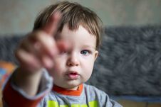 Boy Child Or Small Kid With Serious Face Pointing With His Pointer Finger. Little Boy Points Direction By Forefinger Stock Images