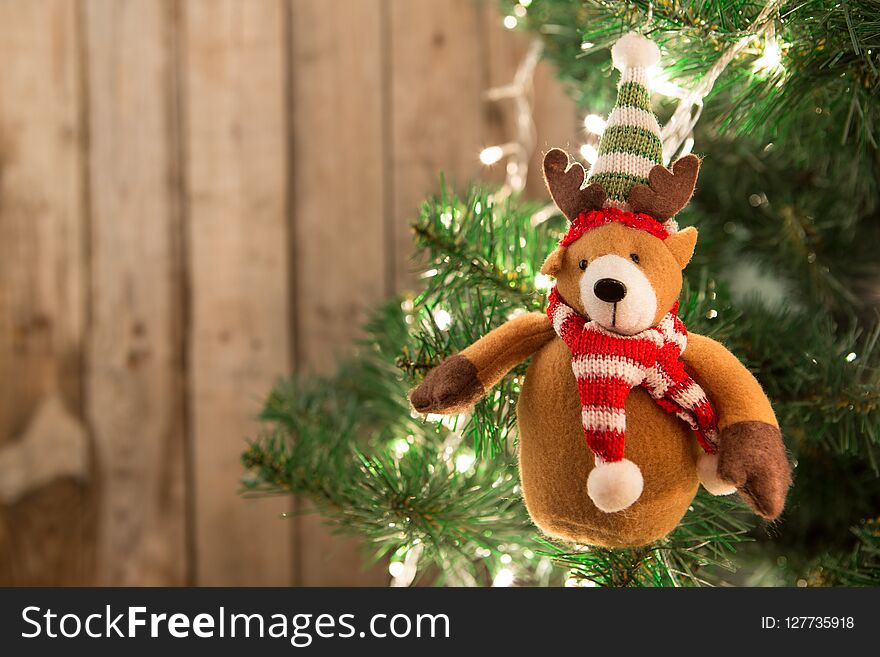 Christmas tree with lights on the wooden background