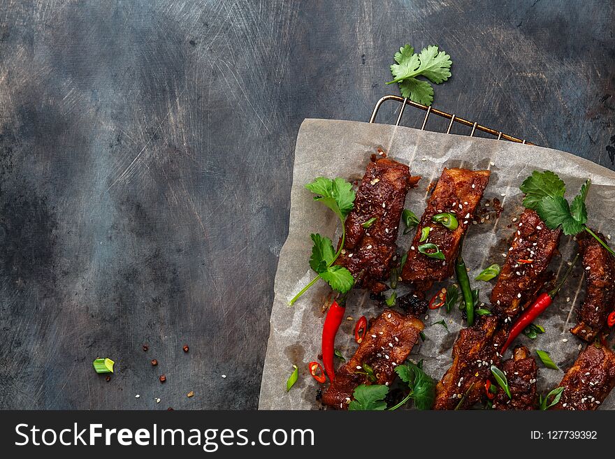 Roasted pork ribs with spicy sauce, copy space