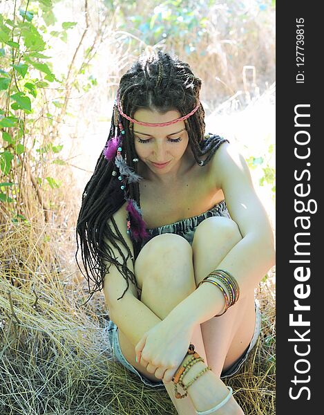 Young Woman With Dreadlocks Resting In Autumn Park