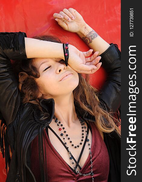 Happy smiling woman portrait against bright red wall, outdoors