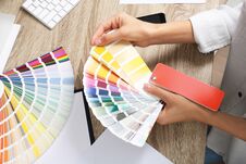 Woman With Color Palette Samples At Table Royalty Free Stock Images