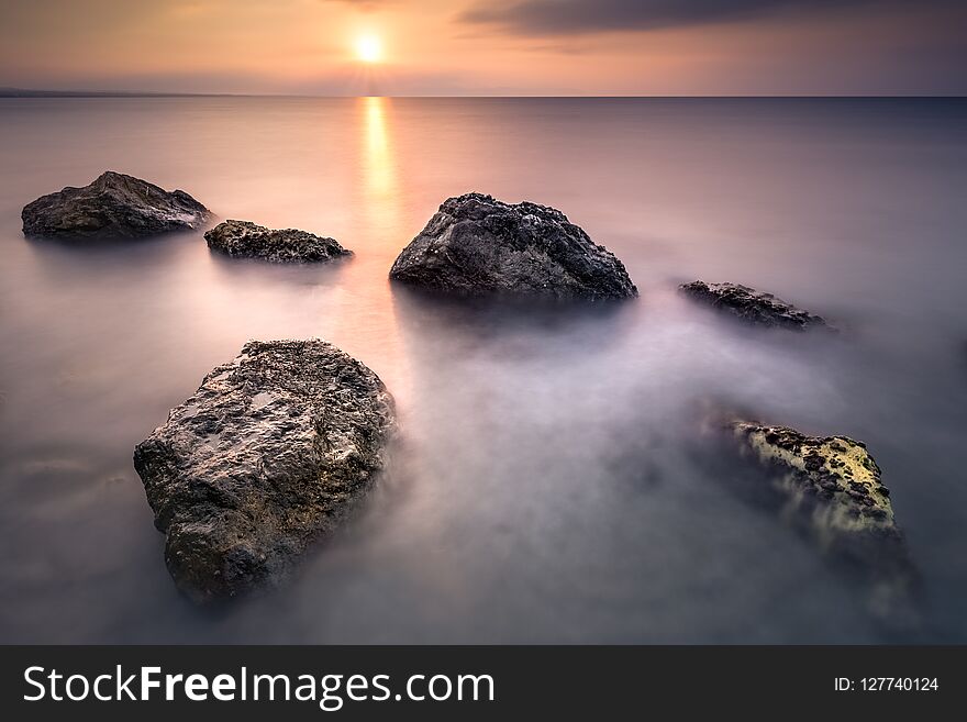 Rocks On The Beach At Sunrise