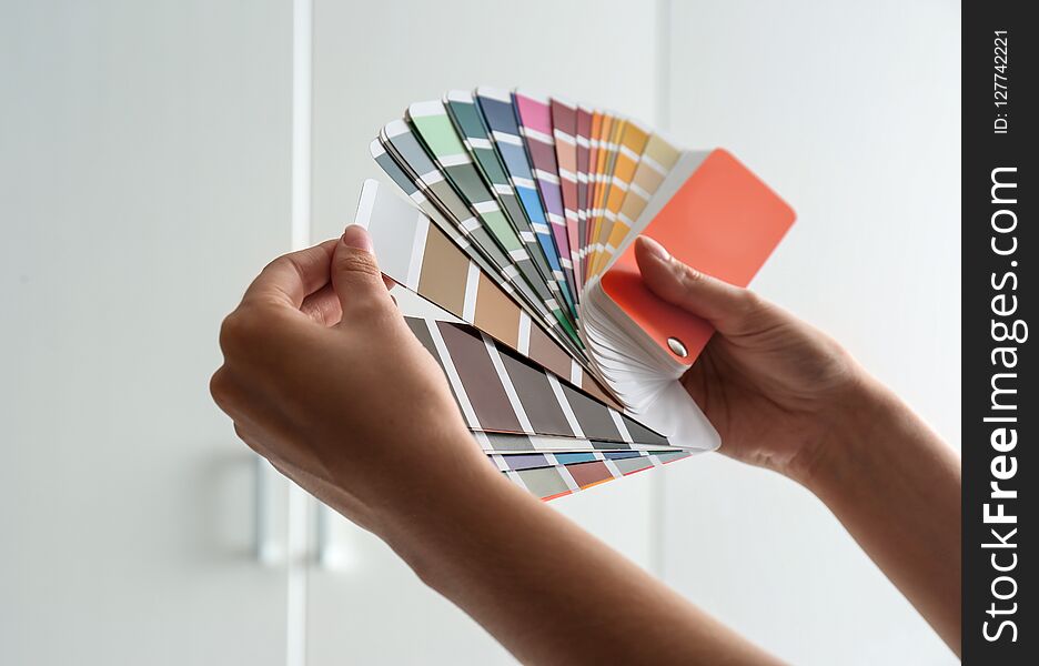 Female interior designer with color palette samples indoors