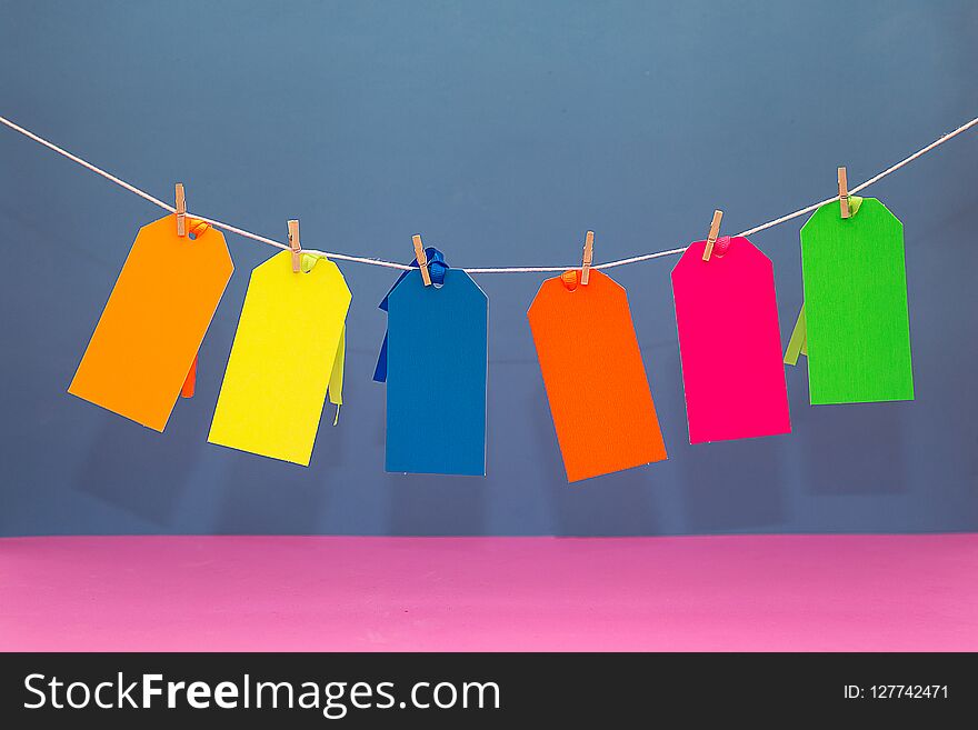 Six Colorful Paperboard Tags Hanging on a String. Six Colorful Paperboard Tags Hanging on a String