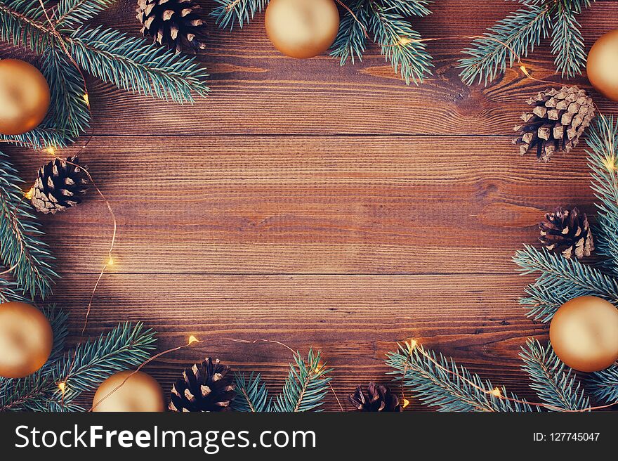 Brown wooden background with festive Christmas decoration, copy space