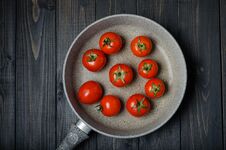 Tomatoes On Dark Rustic Background. Royalty Free Stock Photo