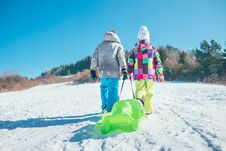 Little Boy And Girl Carry The Sled And Enjoying Winter Sledding Stock Photography