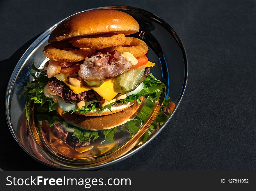 Big tasty burger with various toppings.