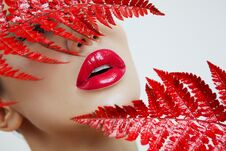 A Woman With Sensual Red Lips And A Fern Royalty Free Stock Images