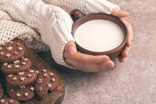 Female Hands Are Holding Cup Of Warm Milk, Chocolate Cookies On Royalty Free Stock Photography Female Hands Are Holding Cup Of Warm Milk, Chocolate Cookies On Royalty Free Stock Photography