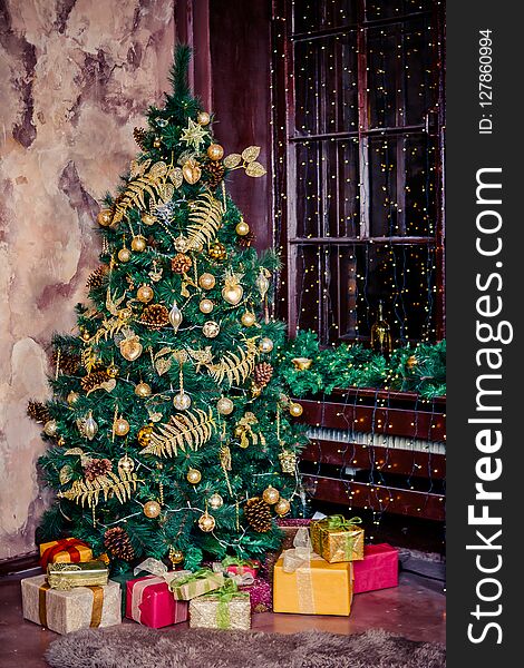 Festively Decorated Home Interior With Christmas Tree.gift Boxes Under The Christmas Tree. Colorful Yellow And Red