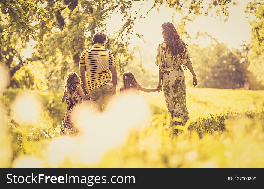 Spring season is best time for walking in nature. Happy family.