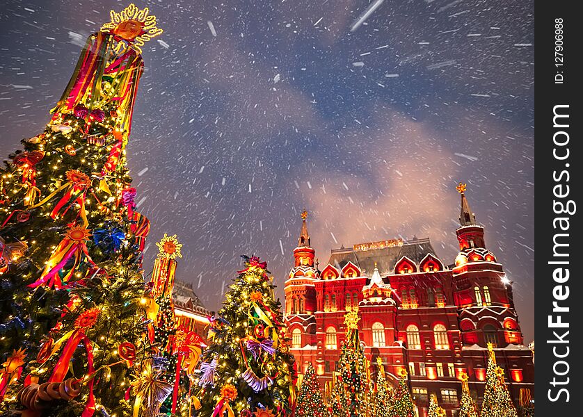 Decorated Christmas trees in honor of the Shrovetide week in Moscow near the Red Square. On the building written text Historical M