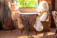 Two Embracing Teddy Bear Toys Sitting On Window-sill Stock Photo
