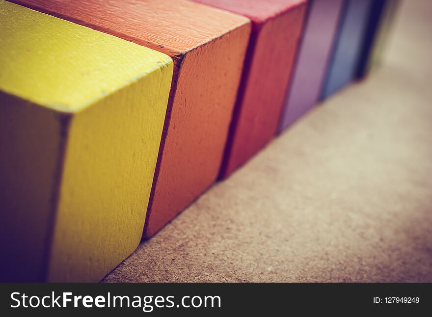 Colorful building blocks on brown background