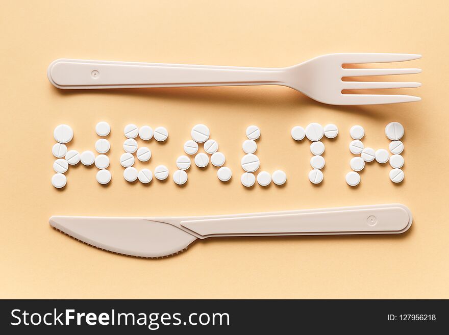 The inscription of the tablets with a knife and fork. Healthy eating concept