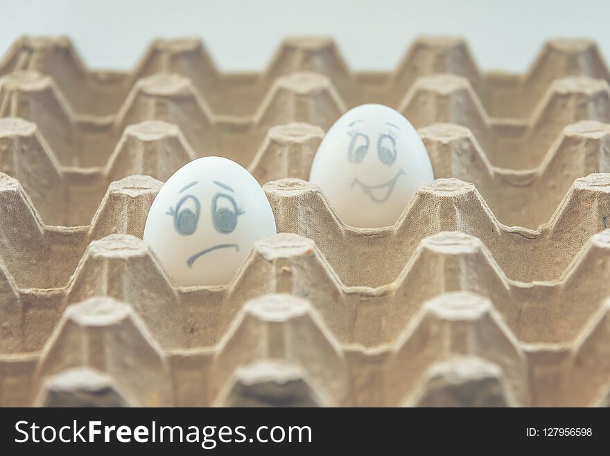 White chicken eggs with painted faces. White chicken eggs with painted faces