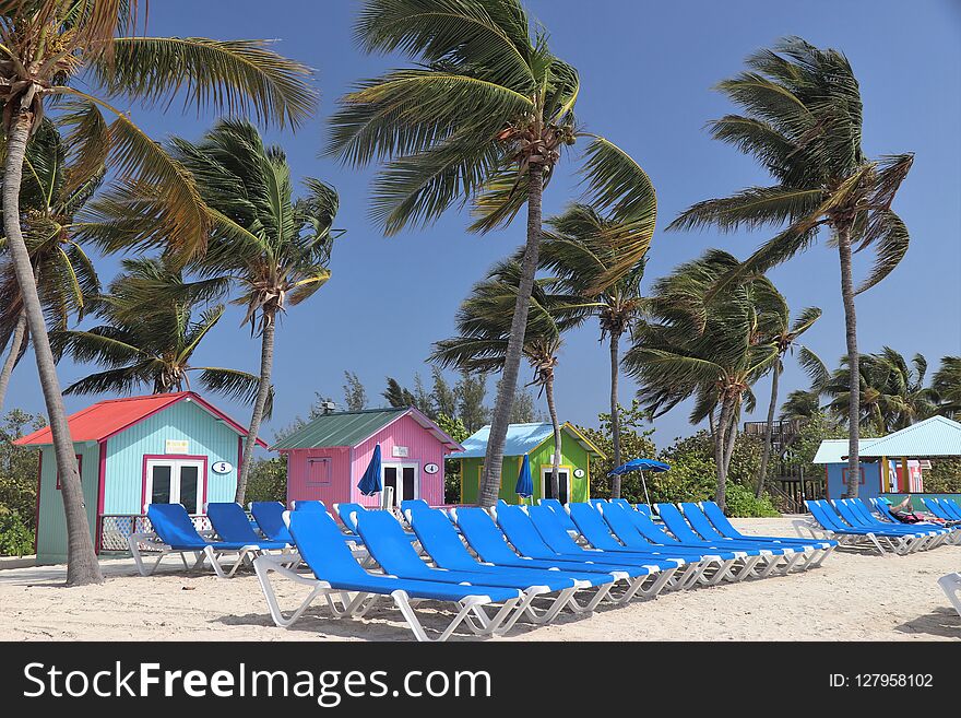 Colorful cabanas and lounge chairs on the beach in Princess Cays