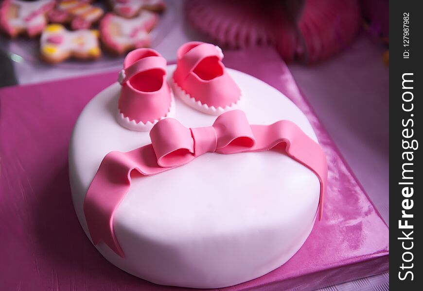 Beautiful children`s pink cake for a newborn girl.