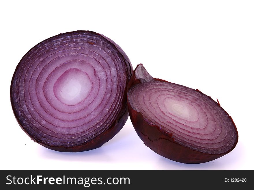 A red onion cut in half and isolated on white background.