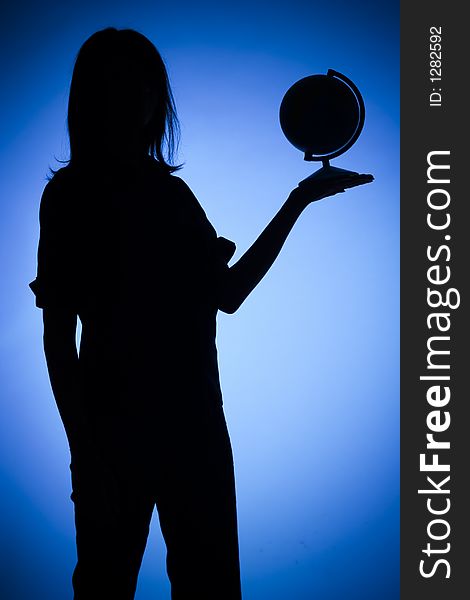 Isolated on blue silhouette of woman with globe