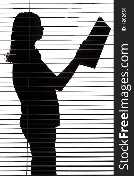 Silhouette of woman with papers