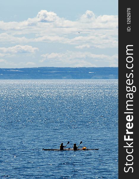 Couple in kayak on blue water. Couple in kayak on blue water