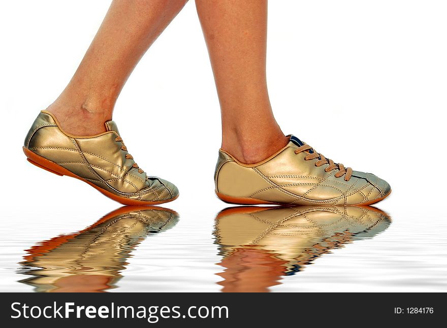 Golden footwear on the water