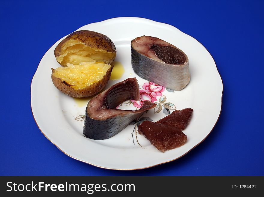 Sliced herring, cavair and potato on a plate. Sliced herring, cavair and potato on a plate