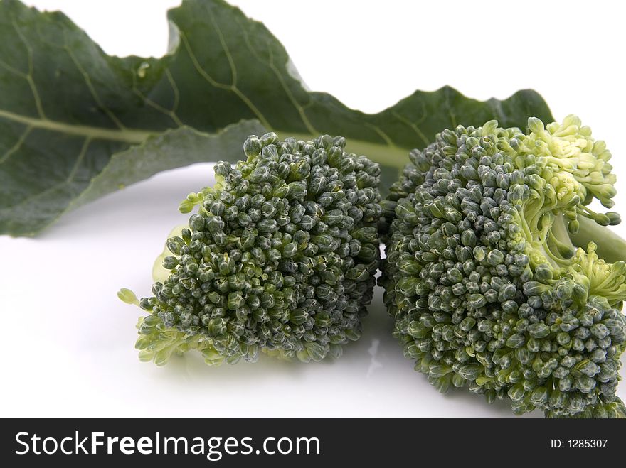 Small stalk of broccoli and a leaf