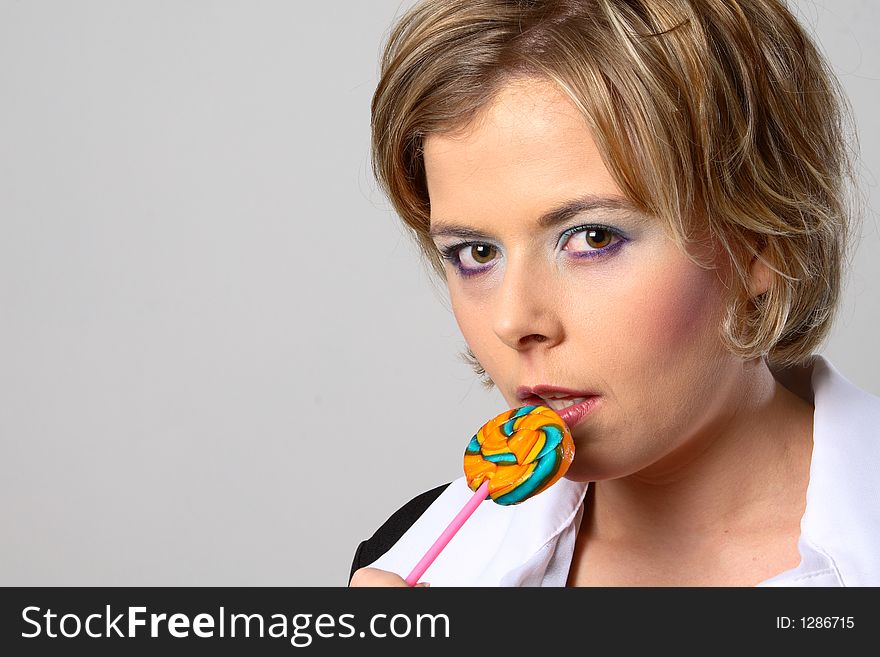 Blond woman with multi-coloured lollipop. Blond woman with multi-coloured lollipop