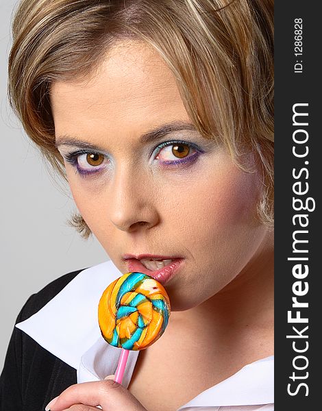 Blond woman with multi-coloured lollipop. Blond woman with multi-coloured lollipop
