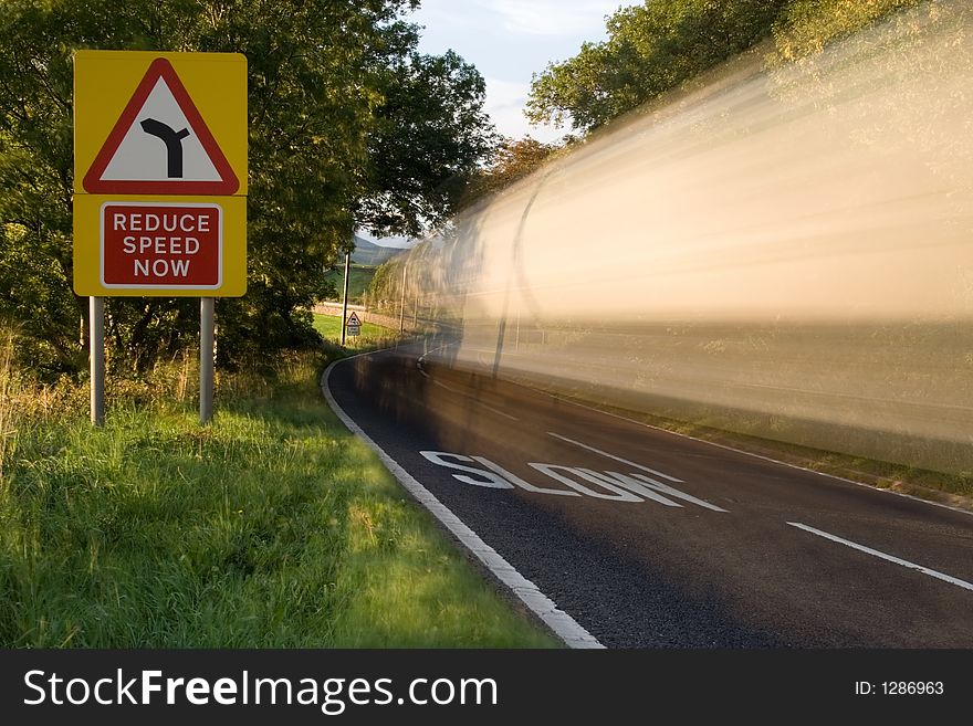 Wagon trundles past reduce speed sign. Wagon trundles past reduce speed sign